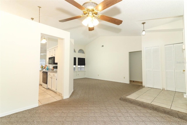 unfurnished living room with lofted ceiling, light carpet, and ceiling fan