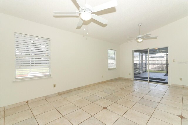 tiled spare room featuring vaulted ceiling and ceiling fan