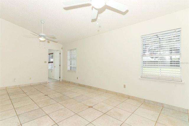 unfurnished room with ceiling fan, light tile patterned floors, and vaulted ceiling