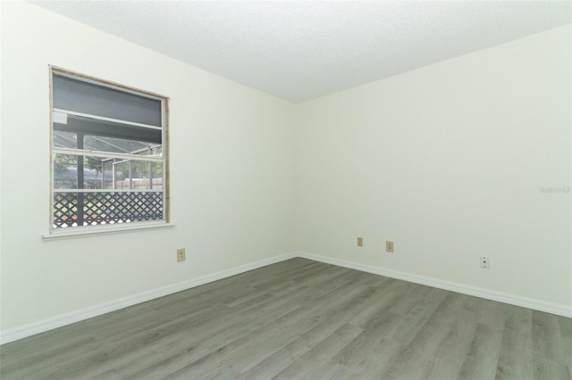 empty room featuring hardwood / wood-style floors and a textured ceiling