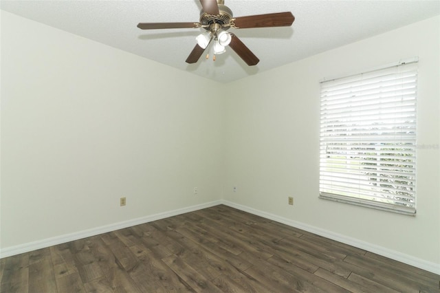 empty room featuring ceiling fan, dark hardwood / wood-style floors, and a textured ceiling