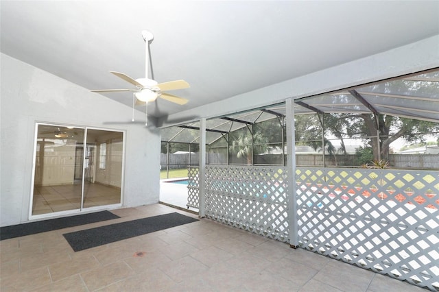 unfurnished sunroom with ceiling fan and lofted ceiling