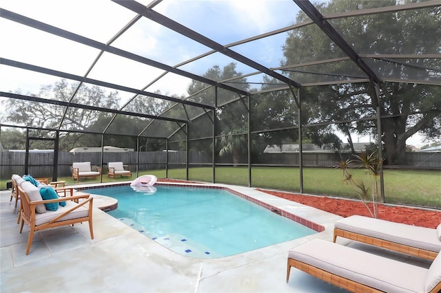 view of pool with a lanai, a lawn, and a patio