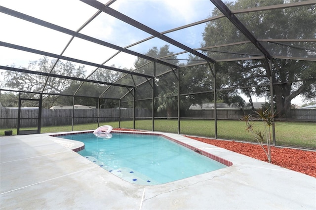 view of swimming pool featuring a lawn, glass enclosure, and a patio