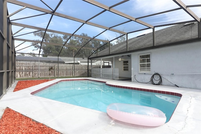 view of pool with a patio, a lanai, and ceiling fan