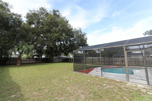 view of yard with a lanai and a fenced in pool