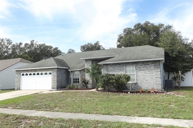 ranch-style home featuring a front lawn and a garage