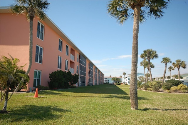 view of property's community with a lawn