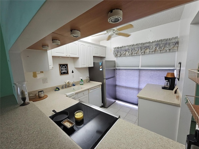 721 S Beach St Unit 217A, Daytona Beach, FL 32114 - kitchen with dishwasher, sink, light tile patterned flooring, stainless steel refrigerator, and white cabinetry