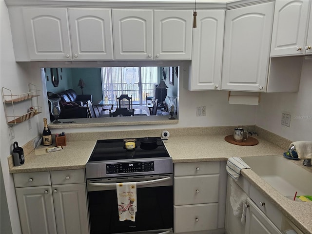 721 S Beach St Unit 217A, Daytona Beach, FL 32114 - kitchen featuring sink, stainless steel range, and white cabinets