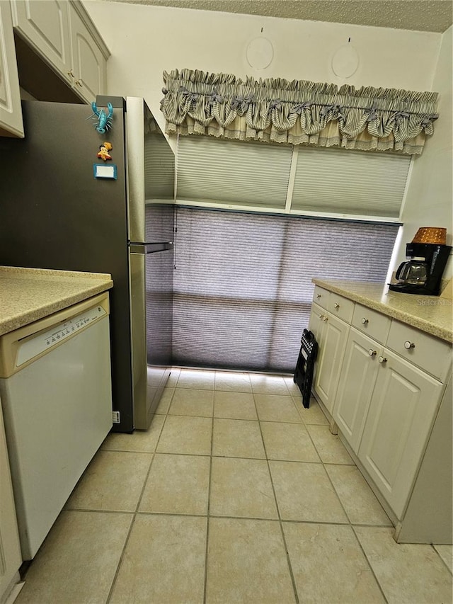 721 S Beach St Unit 217A, Daytona Beach, FL 32114 - kitchen featuring light tile patterned floors and white dishwasher
