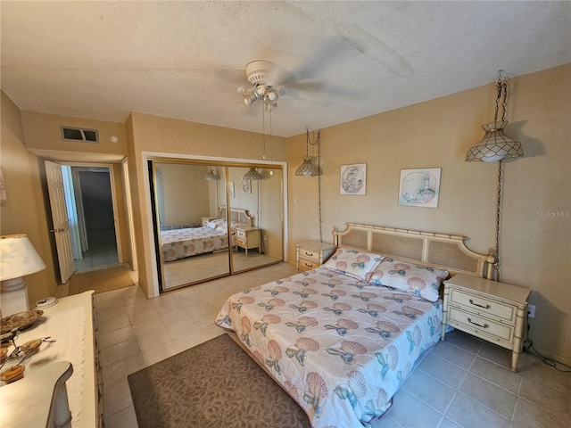 721 S Beach St Unit 217A, Daytona Beach, FL 32114 - tiled bedroom featuring ceiling fan, a textured ceiling, and a closet