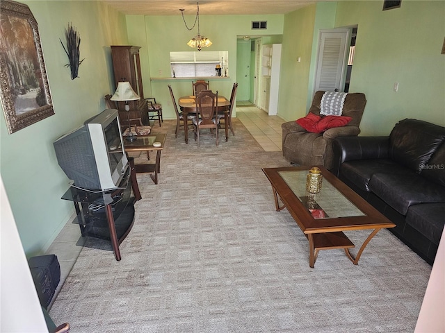 721 S Beach St Unit 217A, Daytona Beach, FL 32114 - tiled living room featuring a notable chandelier