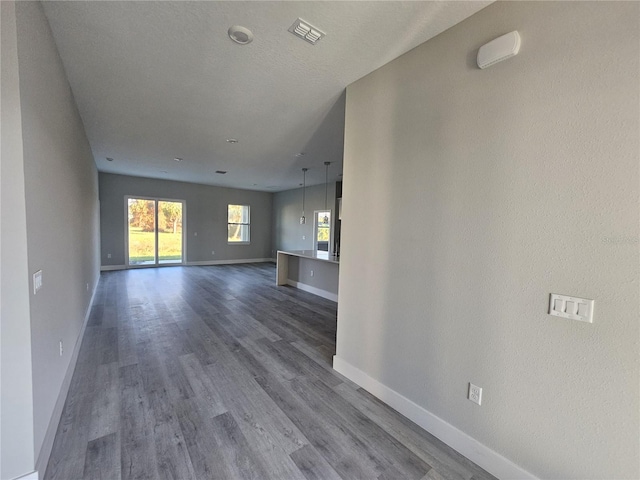 unfurnished living room with dark hardwood / wood-style floors