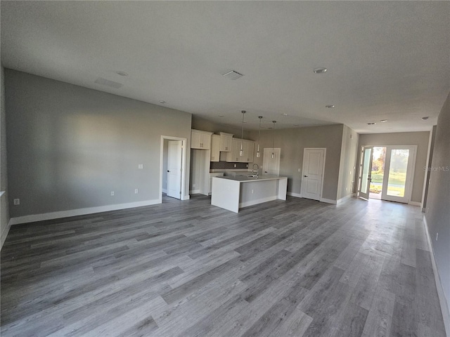 unfurnished living room with hardwood / wood-style floors, a textured ceiling, and sink