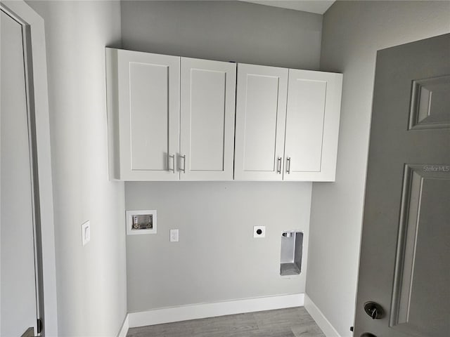 clothes washing area with hookup for an electric dryer, dark wood-type flooring, cabinets, and washer hookup