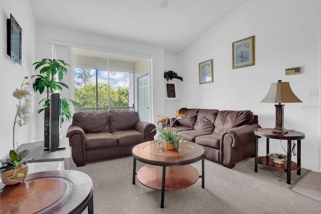 carpeted living room featuring lofted ceiling