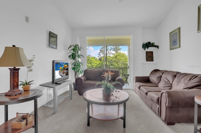 carpeted living room featuring vaulted ceiling