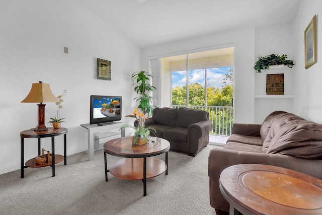 living room with light colored carpet and vaulted ceiling