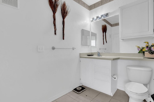 bathroom featuring toilet, vanity, and tile patterned flooring