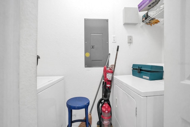 clothes washing area with electric panel and washer and dryer