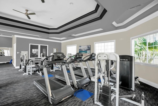 gym featuring ornamental molding, ceiling fan, and dark carpet