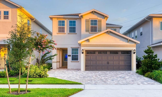 view of front facade featuring decorative driveway and stucco siding