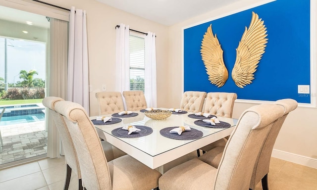 dining room with baseboards and light tile patterned floors