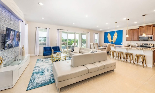 living area featuring baseboards and recessed lighting