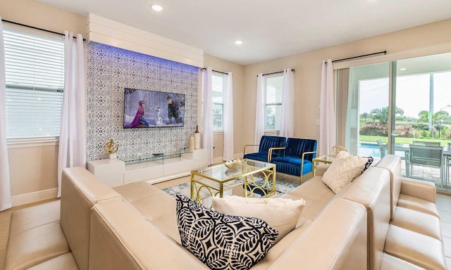 living area featuring baseboards and recessed lighting