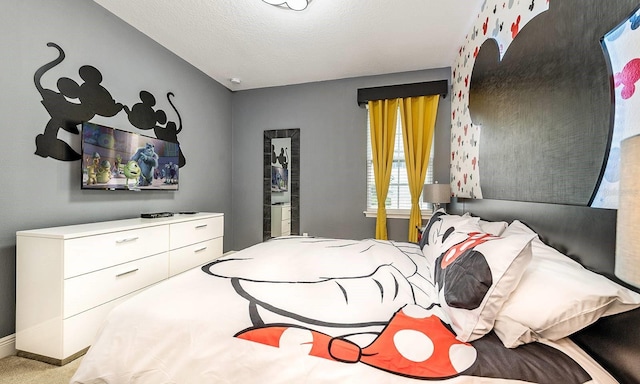 carpeted bedroom with baseboards and a textured ceiling