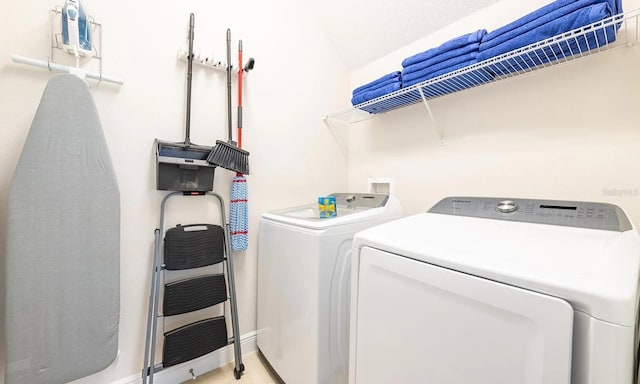 laundry room with laundry area and washer and clothes dryer