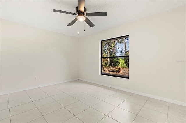 unfurnished room with a textured ceiling, light tile patterned floors, and ceiling fan