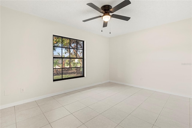 unfurnished room with a textured ceiling, ceiling fan, and light tile patterned flooring