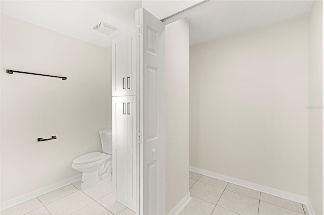 bathroom with tile patterned flooring and toilet