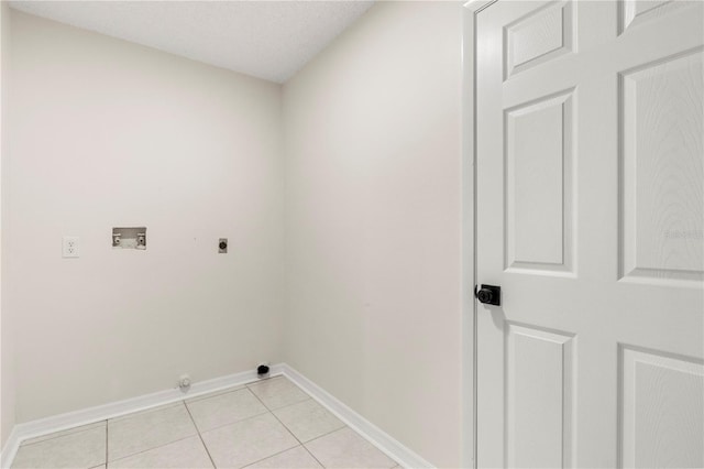 laundry room featuring hookup for a washing machine, electric dryer hookup, a textured ceiling, and light tile patterned flooring