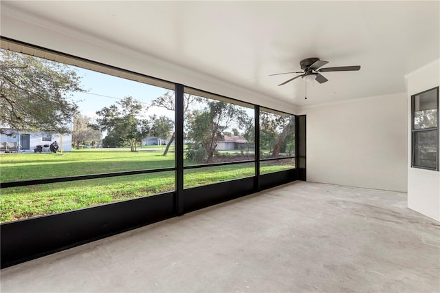 unfurnished sunroom featuring ceiling fan