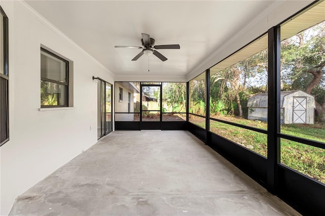 unfurnished sunroom with a wealth of natural light and ceiling fan