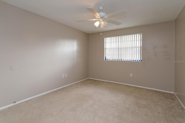 empty room featuring light carpet and ceiling fan