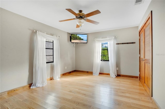 spare room featuring light hardwood / wood-style floors and ceiling fan