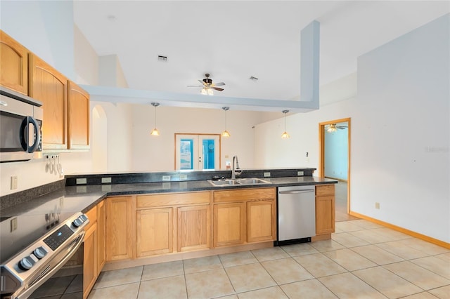 kitchen with stainless steel appliances, hanging light fixtures, sink, and light tile patterned floors