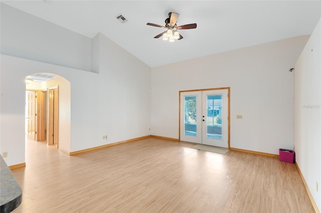 spare room with french doors, ceiling fan, vaulted ceiling, and light hardwood / wood-style flooring