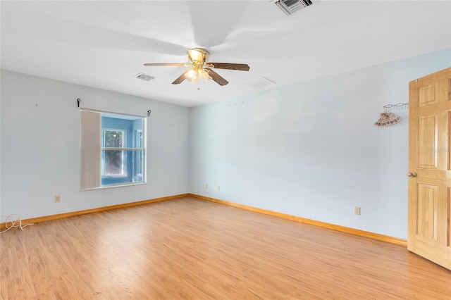 empty room with ceiling fan and light hardwood / wood-style floors