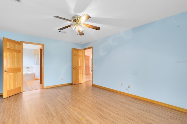 unfurnished bedroom featuring ceiling fan, ensuite bathroom, and light wood-type flooring