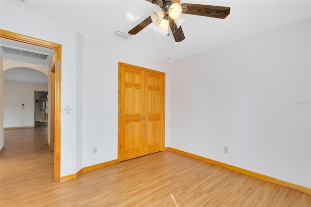 empty room featuring ceiling fan and light hardwood / wood-style floors