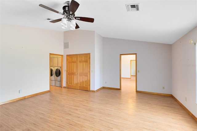 spare room featuring ceiling fan, lofted ceiling, separate washer and dryer, and light hardwood / wood-style floors