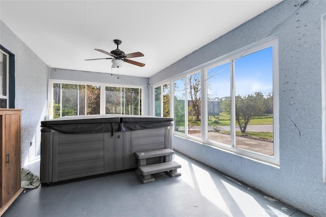 sunroom / solarium with ceiling fan and a jacuzzi