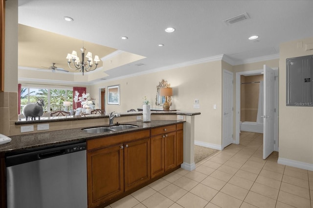 kitchen with ceiling fan with notable chandelier, sink, ornamental molding, stainless steel dishwasher, and dark stone countertops