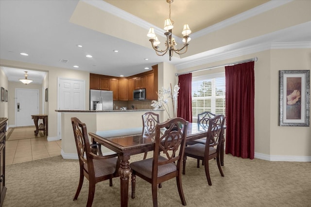 dining area with light colored carpet, a tray ceiling, crown molding, and a notable chandelier