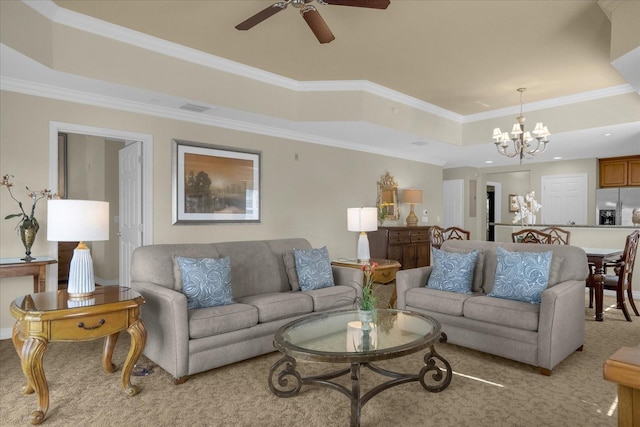 living room featuring ceiling fan with notable chandelier, light carpet, a raised ceiling, and ornamental molding